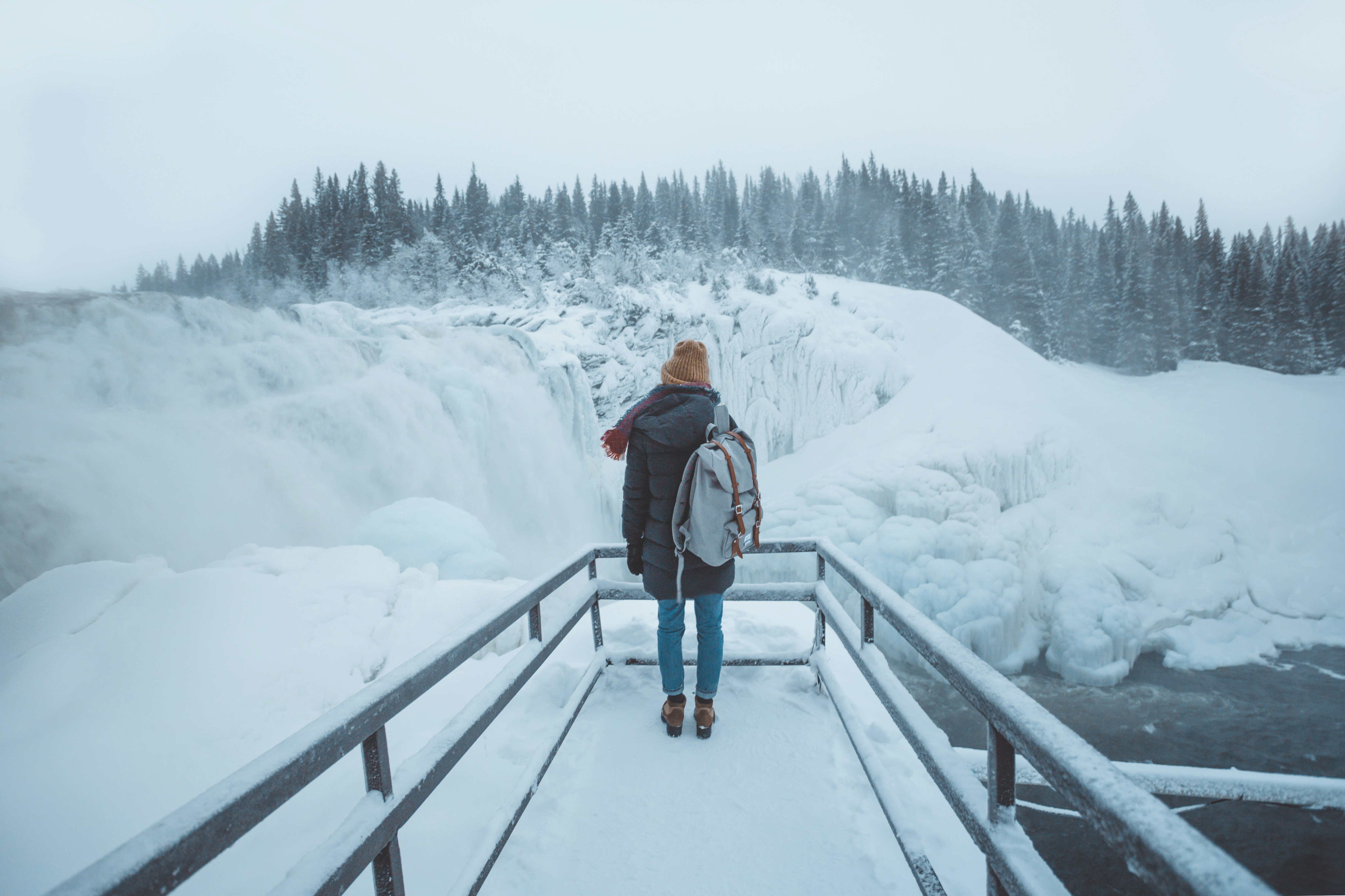 person standing on pier during winter